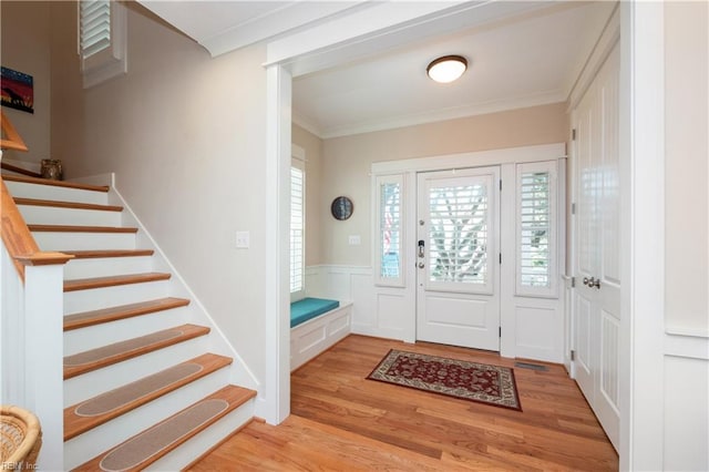 9517 24th Bay St, Norfolk, VA 23518 - foyer entrance with light wood-type flooring, crown molding, healthy amount of natural light, stairway, and a wainscoted wall