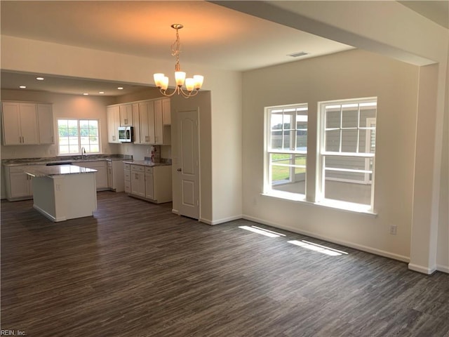 100 Corcoran Ln, Suffolk, VA 23434 - kitchen featuring dark wood-style floors, a chandelier, stainless steel microwave, baseboards, and recessed lighting