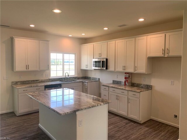 100 Corcoran Ln, Suffolk, VA 23434 - kitchen featuring appliances with stainless steel finishes, white cabinets, a kitchen island, dark wood-style floors, and recessed lighting