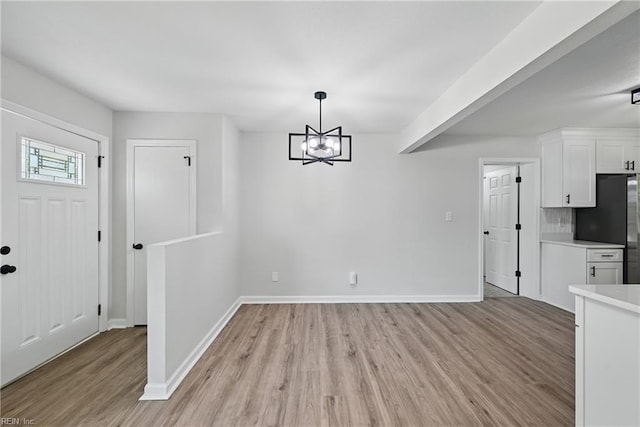 12 Carriage Ln, Newport News, VA 23606 - unfurnished dining area with light wood-style floors, baseboards, and a chandelier