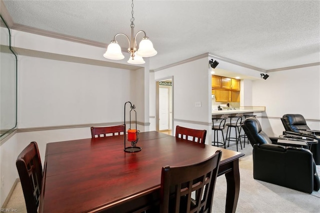 114 Gnarled Oak Ln, Yorktown, VA 23692 - dining space with ornamental molding, a chandelier, a textured ceiling, and light carpet