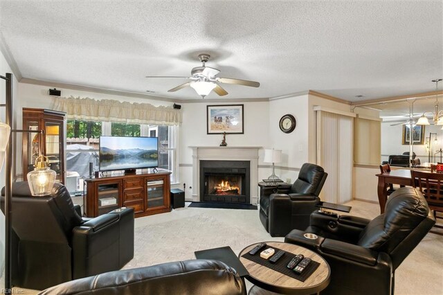 114 Gnarled Oak Ln, Yorktown, VA 23692 - carpeted living room with crown molding, a textured ceiling, ceiling fan, and a warm lit fireplace