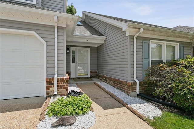 114 Gnarled Oak Ln, Yorktown, VA 23692 - doorway to property featuring roof with shingles, brick siding, and an attached garage