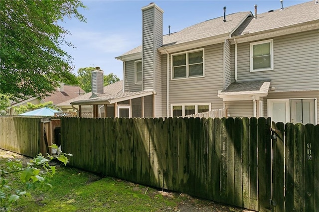 114 Gnarled Oak Ln, Yorktown, VA 23692 - rear view of property with fence, a chimney, and a shingled roof