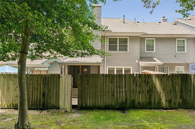 114 Gnarled Oak Ln, Yorktown, VA 23692 - back of property with a chimney, fence, and roof with shingles