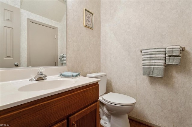 114 Gnarled Oak Ln, Yorktown, VA 23692 - half bathroom featuring vanity, toilet, and wood finished floors