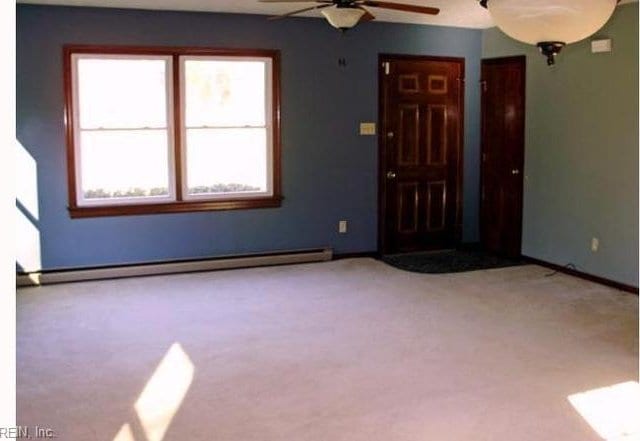 5251 W Run Rd, Charles City, VA 23030 - spare room featuring baseboard heating, ceiling fan, carpet, and baseboards