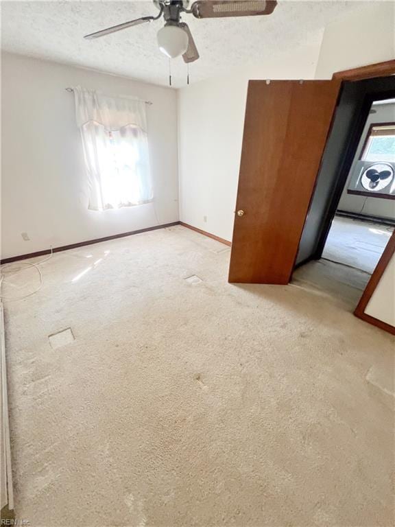 5251 W Run Rd, Charles City, VA 23030 - unfurnished bedroom featuring carpet, a textured ceiling, baseboards, and a ceiling fan