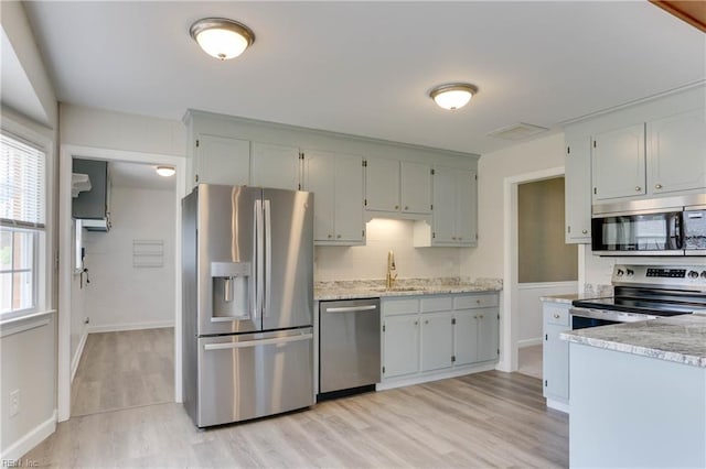 2509 Quail Ridge Ct, Chesapeake, VA 23321 - kitchen with stainless steel appliances, light wood-style flooring, a sink, tasteful backsplash, and baseboards