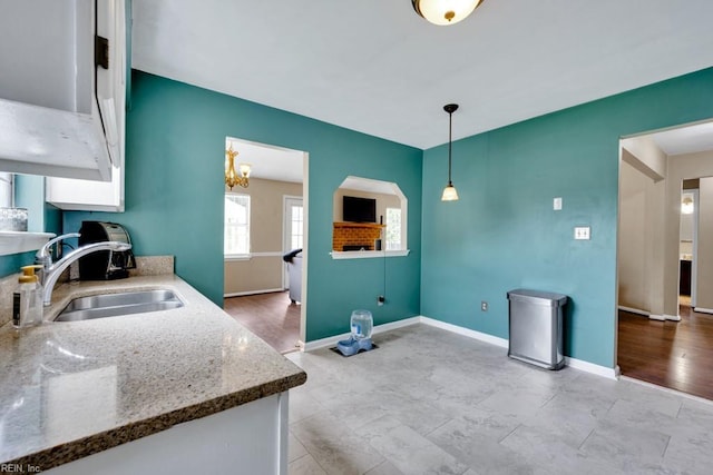 1909 Falling Sun Cir, Virginia Beach, VA 23454 - kitchen featuring a sink, light stone counters, decorative light fixtures, and baseboards