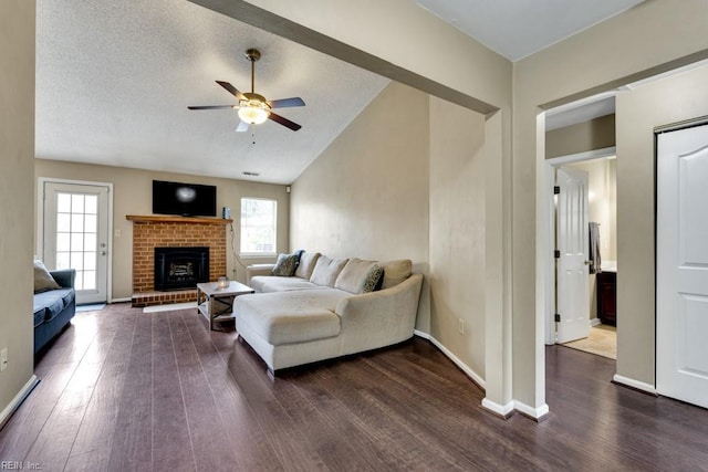 1909 Falling Sun Cir, Virginia Beach, VA 23454 - living area featuring healthy amount of natural light, ceiling fan, dark wood-style floors, a brick fireplace, and vaulted ceiling
