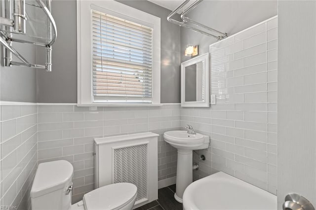 8575 Chesapeake Blvd, Norfolk, VA 23503 - full bathroom with tile walls, toilet, a sink, and wainscoting