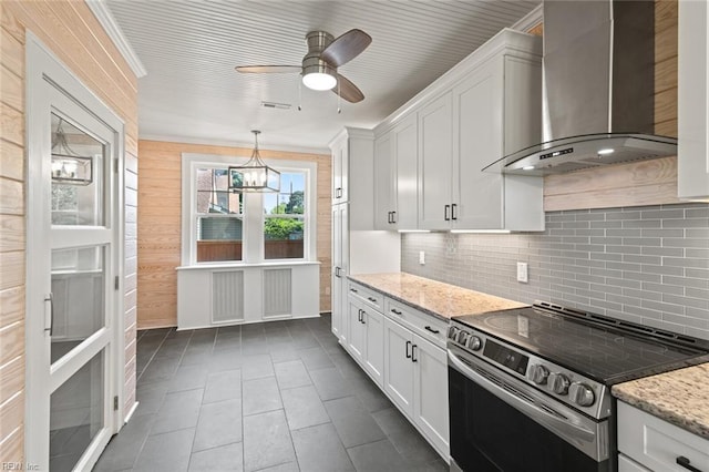 8575 Chesapeake Blvd, Norfolk, VA 23503 - kitchen featuring stainless steel range with electric cooktop, wall chimney range hood, decorative backsplash, and white cabinets