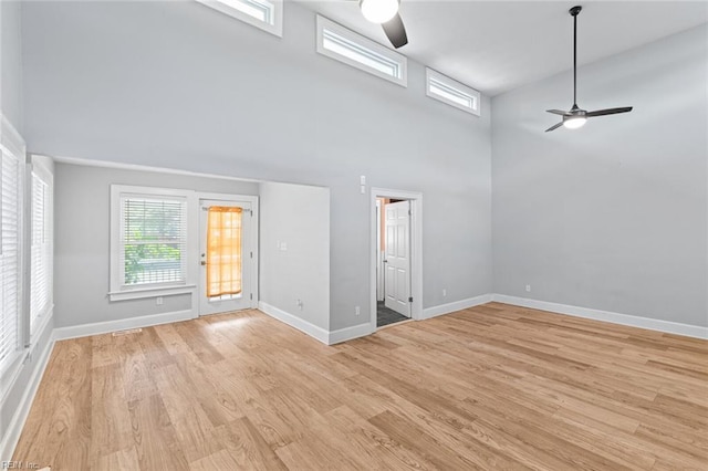 8575 Chesapeake Blvd, Norfolk, VA 23503 - unfurnished room featuring ceiling fan, a high ceiling, healthy amount of natural light, light wood-style flooring, and baseboards