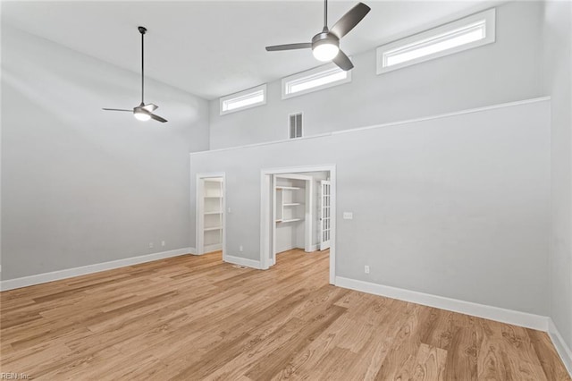 8575 Chesapeake Blvd, Norfolk, VA 23503 - spare room featuring a ceiling fan, baseboards, light wood-style floors, and a towering ceiling