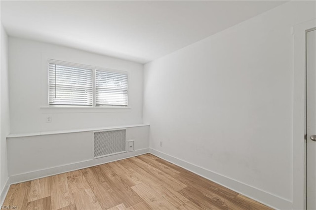 8575 Chesapeake Blvd, Norfolk, VA 23503 - spare room featuring light wood-style flooring, baseboards, and radiator heating unit