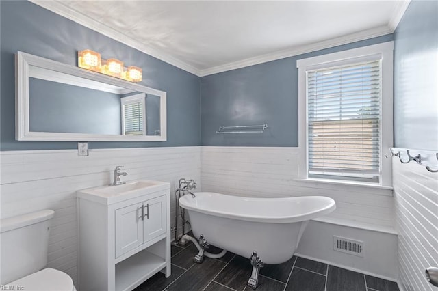 8575 Chesapeake Blvd, Norfolk, VA 23503 - full bathroom featuring a freestanding bath, wainscoting, vanity, toilet, and crown molding