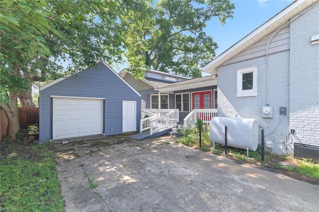 8575 Chesapeake Blvd, Norfolk, VA 23503 - split level home featuring oil tank, driveway, brick siding, fence, and an outdoor structure