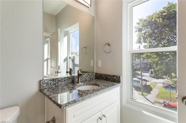 half bath featuring toilet and vanity