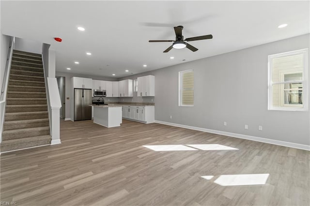 736 A Ave, Norfolk, VA 23504 - unfurnished living room featuring baseboards, a ceiling fan, light wood-type flooring, stairs, and recessed lighting