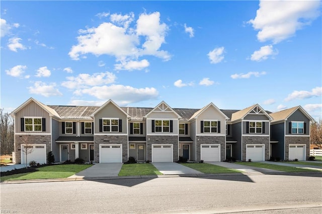 2302 Starling Way, Elizabeth City, NC 27909 - townhome / multi-family property with stone siding, an attached garage, and driveway