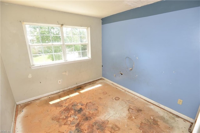 empty room with healthy amount of natural light and baseboards