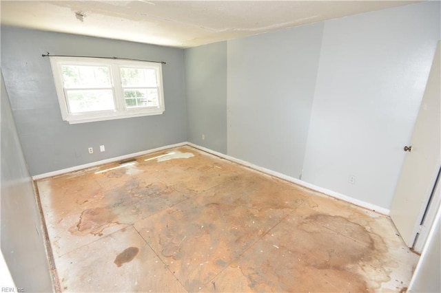 unfurnished room featuring baseboards