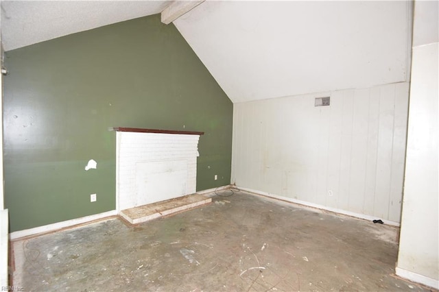 bonus room featuring a brick fireplace