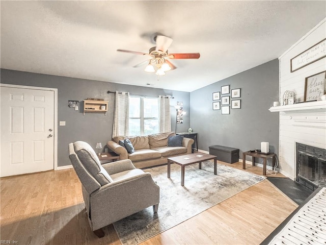 103 Lake St, Chesapeake, VA 23323 - living area with ceiling fan, a large fireplace, wood finished floors, and baseboards
