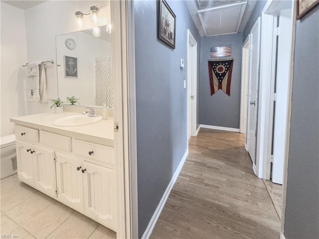 103 Lake St, Chesapeake, VA 23323 - hallway with a sink, attic access, baseboards, and light wood-style floors