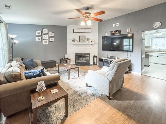 103 Lake St, Chesapeake, VA 23323 - living area featuring ceiling fan, a fireplace, and light wood-type flooring