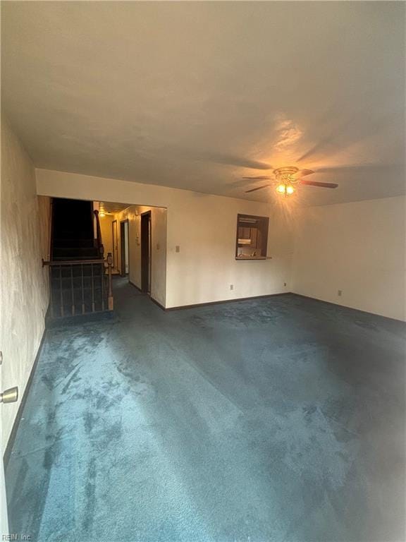 5637 Picadilly Ln, Portsmouth, VA 23703 - unfurnished living room with dark carpet, a ceiling fan, and stairs