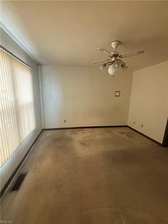 5637 Picadilly Ln, Portsmouth, VA 23703 - unfurnished room featuring light colored carpet, baseboards, and a ceiling fan