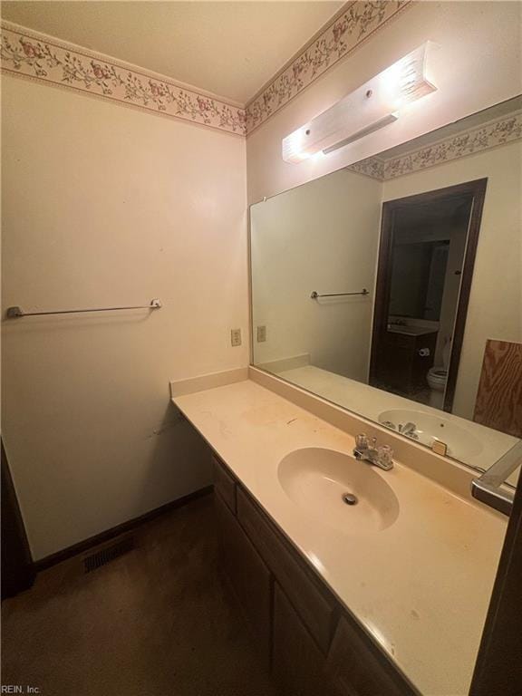 5637 Picadilly Ln, Portsmouth, VA 23703 - bathroom featuring vanity, toilet, and baseboards