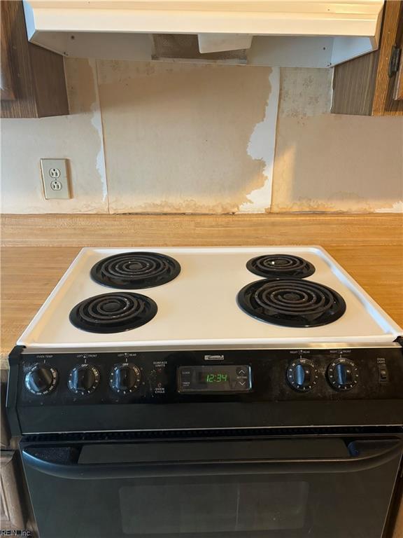 5637 Picadilly Ln, Portsmouth, VA 23703 - kitchen view of black electric range, light countertops, and exhaust hood