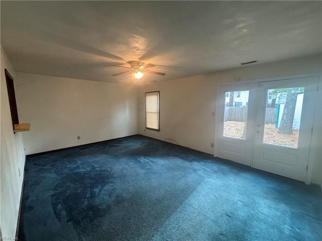 5637 Picadilly Ln, Portsmouth, VA 23703 - empty room featuring dark colored carpet, plenty of natural light, and ceiling fan