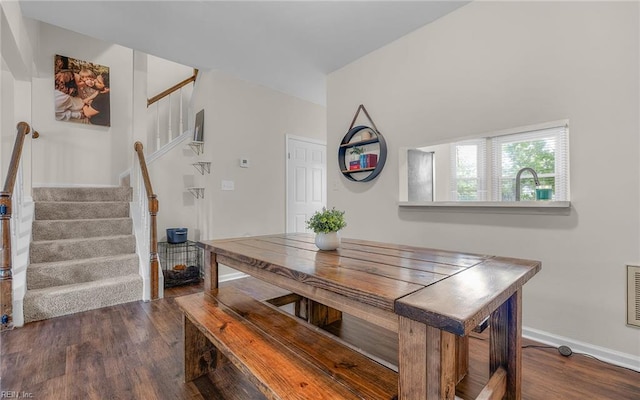 dining room featuring stairway, wood finished floors, and baseboards