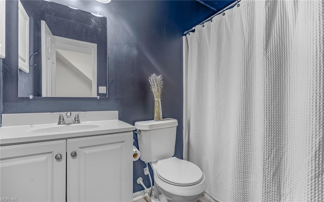 bathroom featuring toilet and vanity