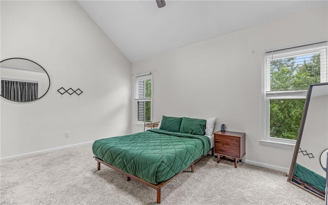 bedroom with carpet flooring, baseboards, lofted ceiling, and a ceiling fan