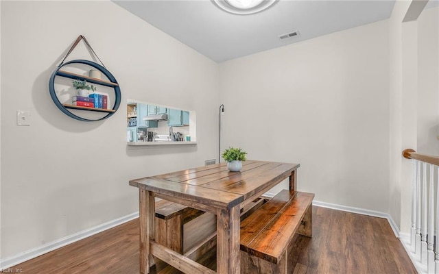 dining space with wood finished floors and baseboards
