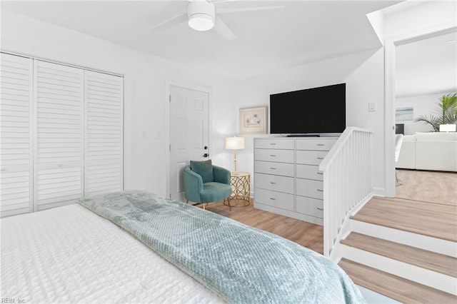 bedroom with wood finished floors, a closet, and ceiling fan