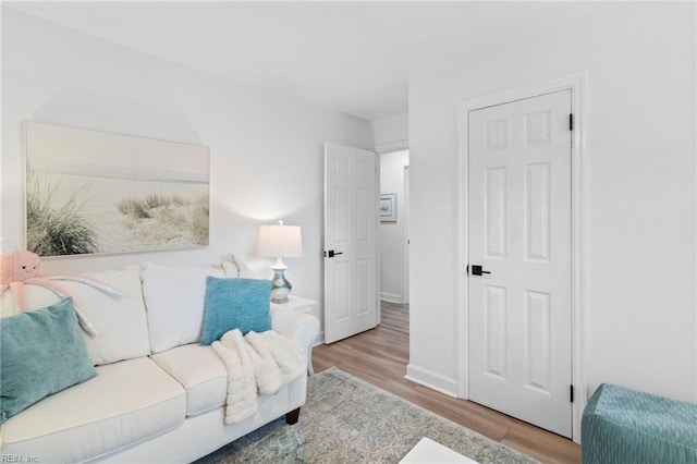 living area with wood finished floors and baseboards