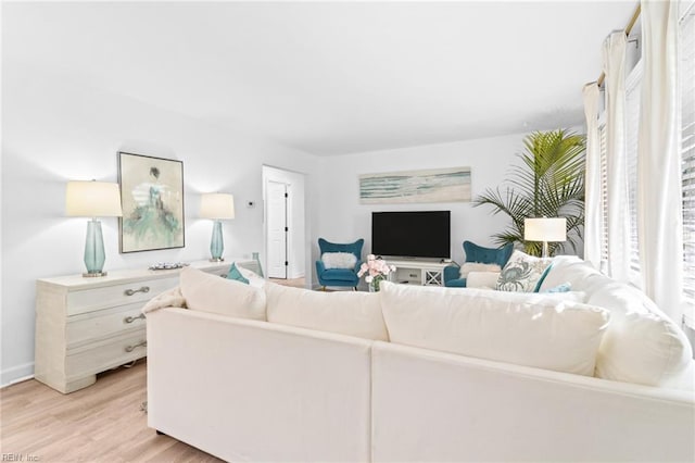 living area with light wood finished floors and baseboards