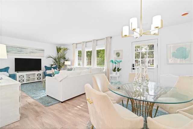 dining area with a chandelier and wood finished floors