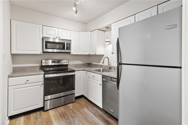 7716 Newport Ave, Norfolk, VA 23505 - kitchen with appliances with stainless steel finishes, a sink, and white cabinets