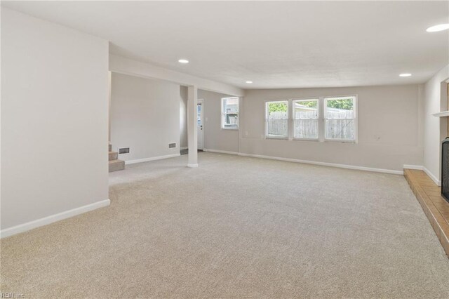 7716 Newport Ave, Norfolk, VA 23505 - unfurnished room featuring light carpet, recessed lighting, baseboards, and a fireplace with raised hearth