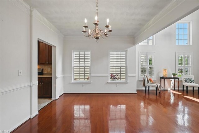 2043 Queens Point Dr, Suffolk, VA 23434 - dining room with a chandelier, wood finished floors, and crown molding