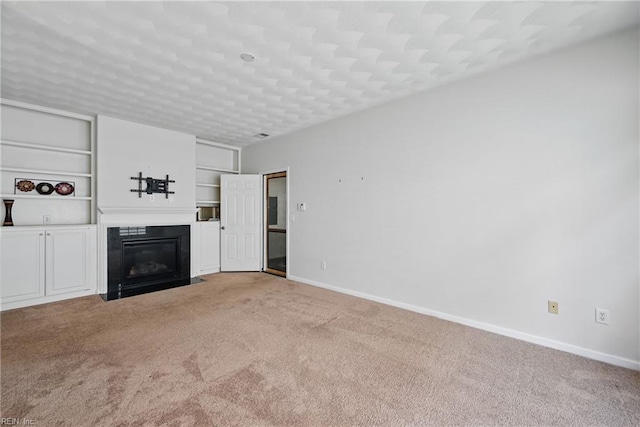 2043 Queens Point Dr, Suffolk, VA 23434 - unfurnished living room featuring carpet, a fireplace with flush hearth, baseboards, and built in shelves