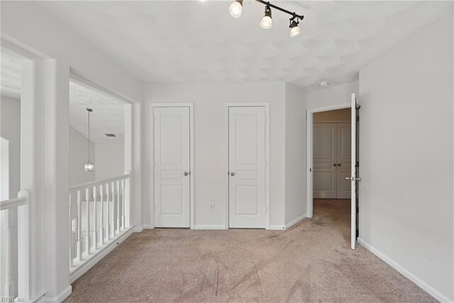 2043 Queens Point Dr, Suffolk, VA 23434 - unfurnished bedroom with carpet floors, baseboards, and track lighting