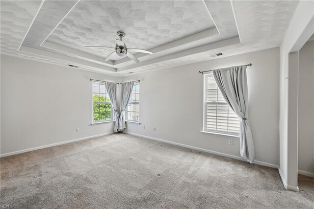 2043 Queens Point Dr, Suffolk, VA 23434 - carpeted spare room featuring a tray ceiling, a ceiling fan, and baseboards